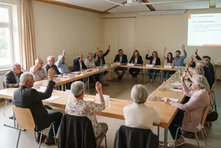 Abstimmung in einer Eigentümerversammlung einer WEG in Köln – Stimmkarten und Protokollbuch